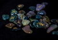 Selective focus shot of a set of ancient runes to guess the future on a black surface