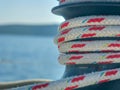 Selective focus shot of ship rope tied on a dock on blue background Royalty Free Stock Photo