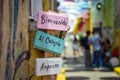 Selective focus shot of a sign in Spanish which says 'Bienvenido Al Callejon Angosto'