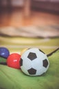 Selective focus shot of a soft toy soccer ball with plastic balls behind it. Royalty Free Stock Photo