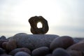 Selective focus shot of a stone with a hole on the beach Royalty Free Stock Photo