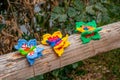 Selective focus shot of three knitted butterflies perching on the log