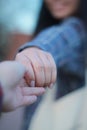 Selective focus shot of two people holding hands as a sign of mutual love Royalty Free Stock Photo