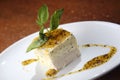 Selective focus shot of vanilla cake with mango and chocolate sauce on white plate Royalty Free Stock Photo