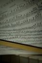 Selective focus shot of a violin bow and sheet music on piano keys Royalty Free Stock Photo