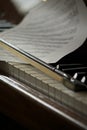 Selective focus shot of a violin bow and sheet music on piano keys Royalty Free Stock Photo