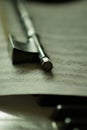 Selective focus shot of a violin bow and sheet music on piano keys Royalty Free Stock Photo