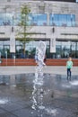 Selective focus shot of a water fountain in front of a modern building Royalty Free Stock Photo