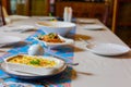 Selective focus shot of well prepared food on table with silverware and plates in restaurant shows concept of event celebration Royalty Free Stock Photo