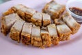 Selective focus, sliced crispy belly pork served on pink plate. Royalty Free Stock Photo