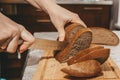 Selective focus on slices of rye bread cut from a loaf with a knife. Royalty Free Stock Photo