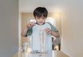 Selective focus smart kid building the tower stack from wooden blocks toy Happy Child boy playing stack of wood cube in living Royalty Free Stock Photo