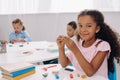 selective focus of smiling african american kid with plasticine Royalty Free Stock Photo