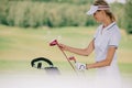 selective focus of smiling female golf player in cap with golf gear Royalty Free Stock Photo