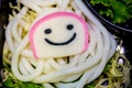 Selective focus on smiling fish ball and BBQ grill pork on noodle or udon,Thai cooking food ready to eat in restaurant.