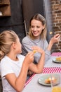 selective focus of smiling mother having lunch together with daughter Royalty Free Stock Photo