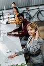 Selective focus of smiling multiethnic call center operators working Royalty Free Stock Photo