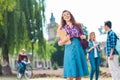 selective focus of smiling student with notebook and multicultural classmates behind Royalty Free Stock Photo
