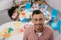 selective focus of smiling teacher in eyeglasses and interracial kids at table Royalty Free Stock Photo