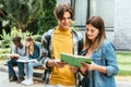 Focus of smiling teenagers reading book Royalty Free Stock Photo