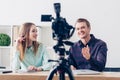 Selective focus of smiling video bloggers recording vlog Royalty Free Stock Photo