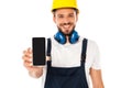 Focus of smiling workman showing smartphone with blank screen isolated on white