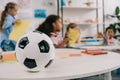 selective focus of soccer ball on table and multiracial preschoolers Royalty Free Stock Photo