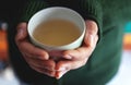 Selective focus and Soft focus / Woman hands holding hot cup of coffee or tea. Royalty Free Stock Photo