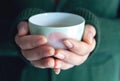 Selective focus and Soft focus / Woman hands holding hot cup of coffee or tea, With a winter Royalty Free Stock Photo