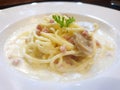 Selective focus of spaghetti carbonara with cream sauce, bacon and mushrooms on white plate Royalty Free Stock Photo
