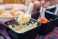 Selective focus of stainless steel short spoon of chopped garlic on table in the kitchen