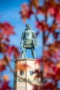 Selective focus of the statue of Prince Lazar in Serbia seen behind red red