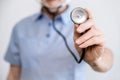 selective focus on stethoscope in male doctor cardiologist hand Royalty Free Stock Photo