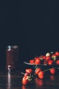 selective focus of strawberries in silver tray and fruit jam in jar Royalty Free Stock Photo