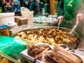 Street food vendor cooking up spicy mushrooms