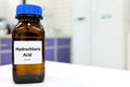 Selective focus of strong hydrochloric acid chemical in brown amber glass bottle inside a laboratory with copy space. Royalty Free Stock Photo
