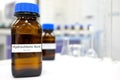 Selective focus of strong Hydrochloric acid solution in brown amber bottle. Blur laboratory backdrop with copy space. Royalty Free Stock Photo