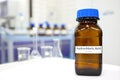 Selective focus of strong Hydrochloric acid solution in brown amber bottle. Blur laboratory backdrop with copy space. Royalty Free Stock Photo