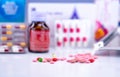 Selective focus on tablets and capsule pills on blurred background of drug bottle, blister pack of pills, and drug tray. Drugstore Royalty Free Stock Photo