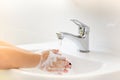 Selective focus of tap water children washing hands with soap un Royalty Free Stock Photo