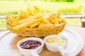 Selective focus Tasty French fries or potato fry with salt served in a wooden basket with tomato ketchup and mayonnaise .Fastfood