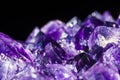 Selective focus technique of healing amethyst purple crystal isolated on black