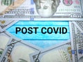 Selective focus.Text POST COVID on a face mask with banknote.Crisis economic concept. Royalty Free Stock Photo