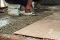 Selective focus on the texture of mixed cement and dirty surface of floor tiles in the house under construction with blurred Royalty Free Stock Photo