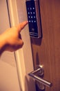 Selective focus to access code on the digital door lock system by pressing a index finger on button Royalty Free Stock Photo