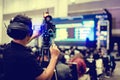 Selective focus to cameraman and video camera set are recording to speaker and audience in conference hall or seminar event