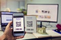 Selective focus to customer hand holding smart phone to scan Qr code payment