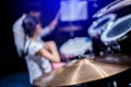 Selective focus to cymbals of drum set with blurry kid learning and play drum set with teacher in music room. Royalty Free Stock Photo