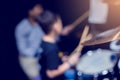 Selective focus to cymbals of drum set with blurry kid learning and play drum set with teacher in music room. The concept of Royalty Free Stock Photo