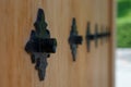 Selective focus to decorative black metal rivet on blurred surface of traditional Japanese wooden door gate Royalty Free Stock Photo